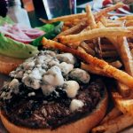 Plate with spicy bleu cheeseburger and fries